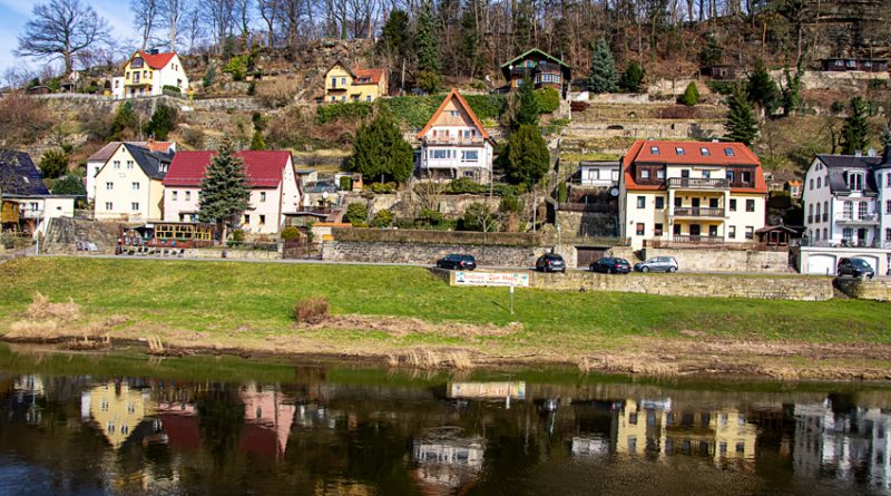 Colorful traditional German houses on a hillside reflected in the Elbe River