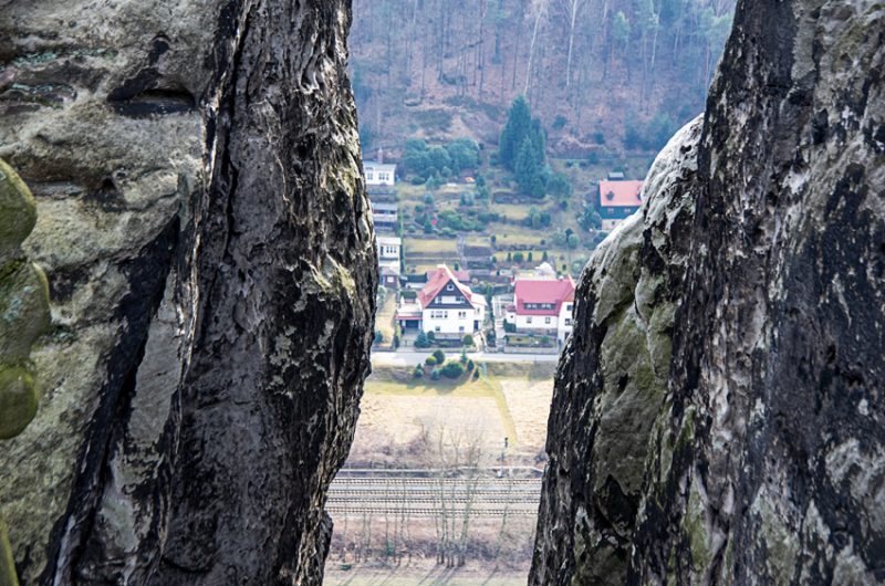 Peeking through a gap in the rock formations from the Switzerland of Saxony National Park on the lower bank of the Elbe River.