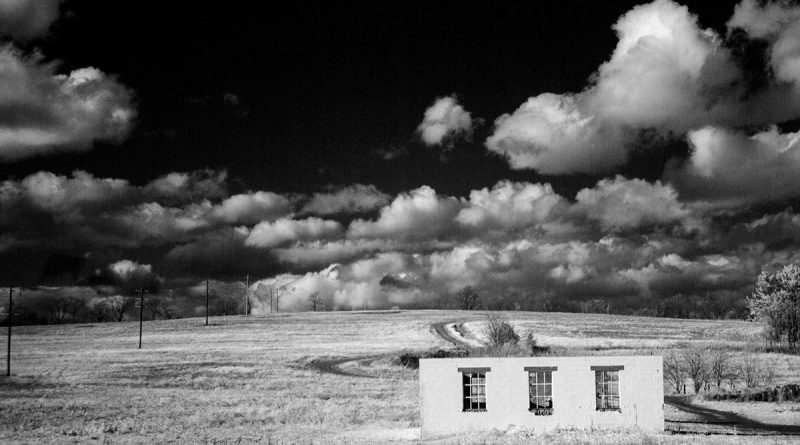 ilious clouds in black sky with a gutted, roofless building int he foreground. This was part of the preparations for constructing a giant logistics center in Perry Township