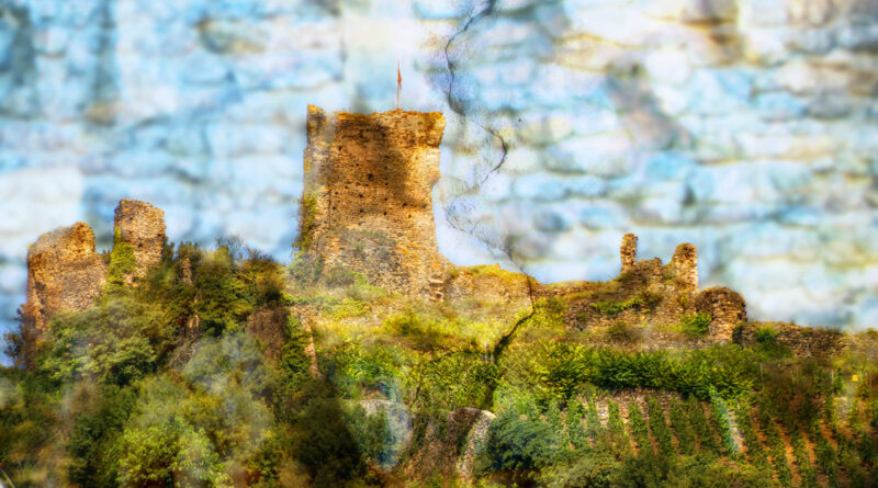 A Crack in the Textures of History- a composite photo of a the ruins of a French castle on a hillside above a vineyard.