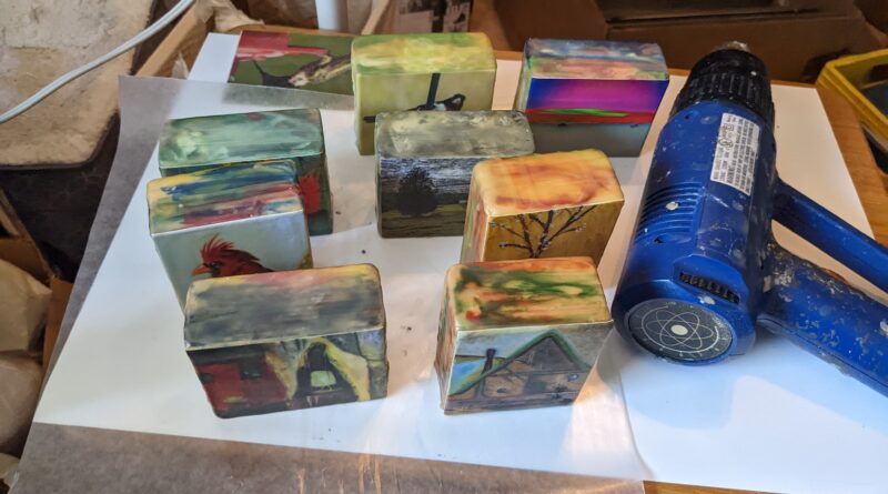 Wooden blocks with photograph or small giclee reproduction of a painting embedded in encaustic Medium.